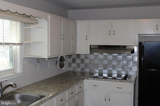 kitchen featuring tasteful backsplash, sink, white cabinets, and black appliances