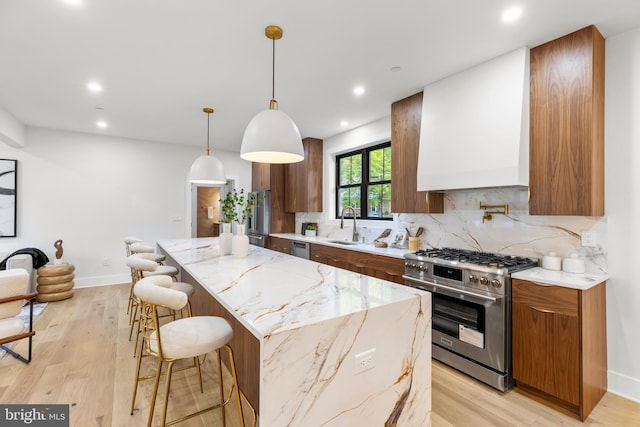 8206 Grubb Rd, Chevy Chase, MD 20815 - kitchen with high quality appliances, custom exhaust hood, a sink, decorative backsplash, and a breakfast bar area