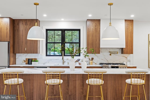 8206 Grubb Rd, Chevy Chase, MD 20815 - kitchen with brown cabinetry, decorative backsplash, modern cabinets, stove, and decorative light fixtures