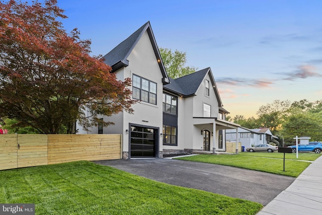8206 Grubb Rd, Chevy Chase, MD 20815 - contemporary house featuring stucco siding, driveway, stone siding, roof with shingles, and a garage