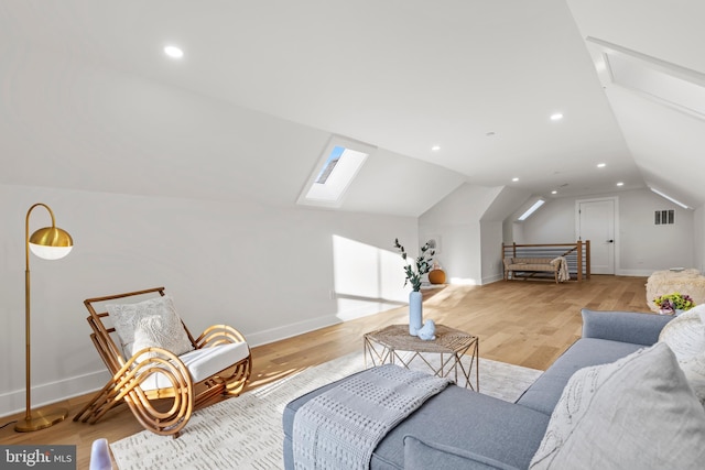 8206 Grubb Rd, Chevy Chase, MD 20815 - living area featuring a skylight, vaulted ceiling, light wood finished floors, baseboards, and recessed lighting
