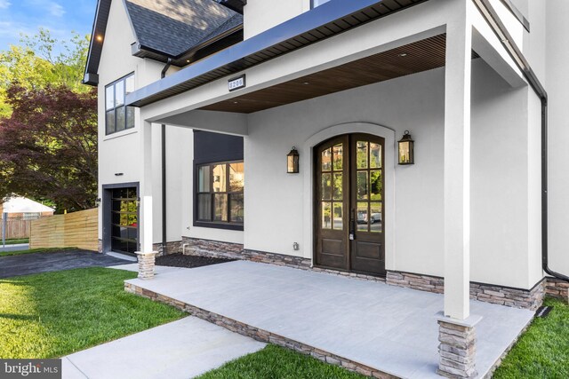 8206 Grubb Rd, Chevy Chase, MD 20815 - doorway to property featuring french doors, stucco siding, and fence