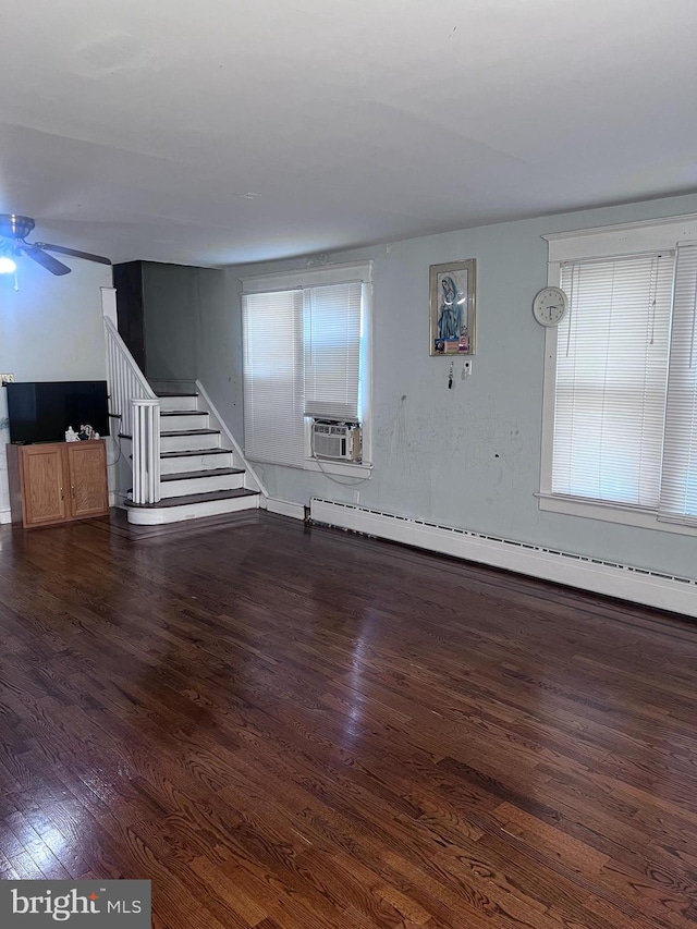 interior space featuring dark hardwood / wood-style flooring, cooling unit, ceiling fan, and a baseboard heating unit