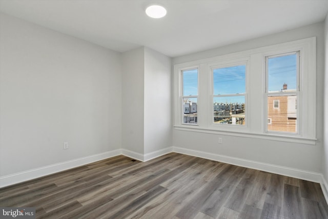 unfurnished room with hardwood / wood-style flooring