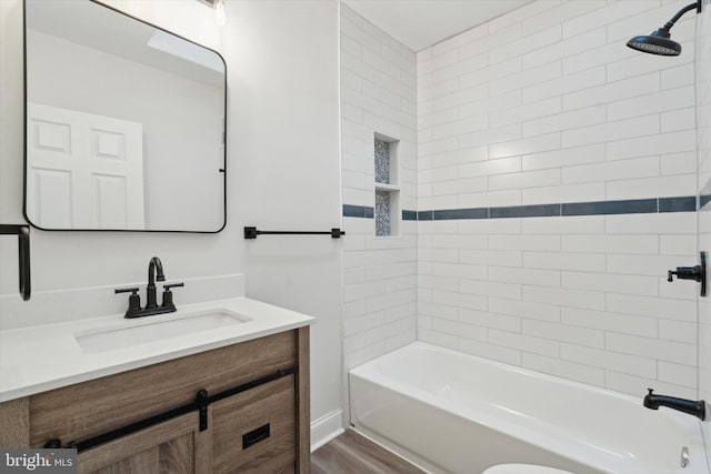 bathroom featuring vanity, tiled shower / bath combo, and hardwood / wood-style flooring