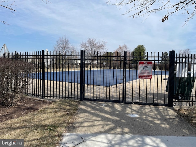 view of gate with fence