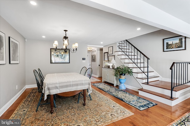 dining space featuring a chandelier and wood-type flooring