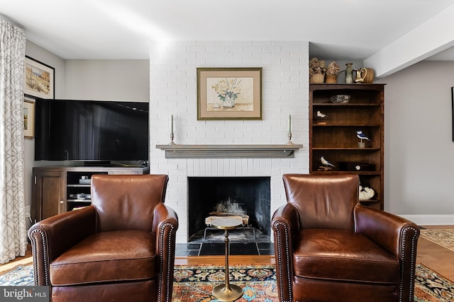 living area with a fireplace and hardwood / wood-style floors