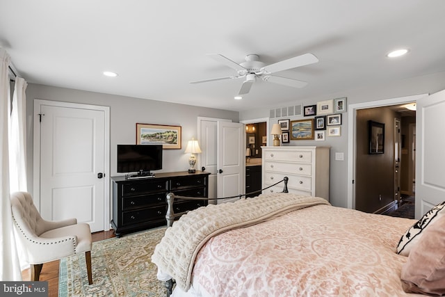 bedroom with dark hardwood / wood-style flooring and ceiling fan