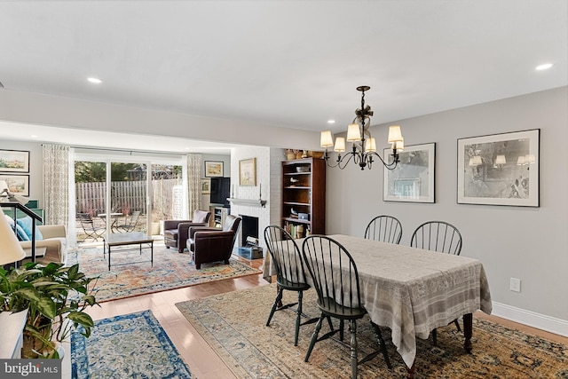 dining space with a notable chandelier and hardwood / wood-style flooring