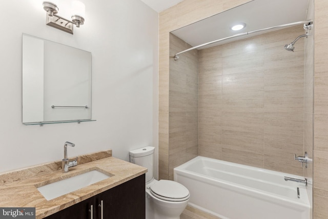 full bathroom featuring toilet, vanity, and tiled shower / bath combo