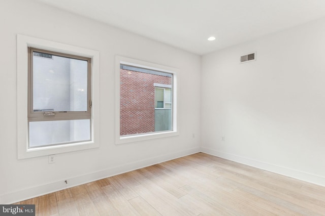 empty room with light hardwood / wood-style flooring