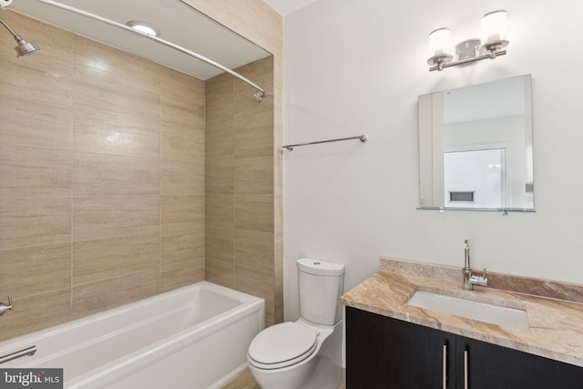 full bathroom with vanity, toilet, and tiled shower / bath combo