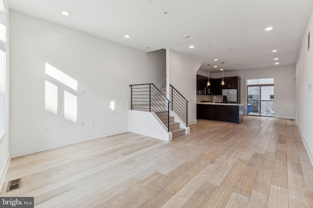 unfurnished living room with light hardwood / wood-style floors