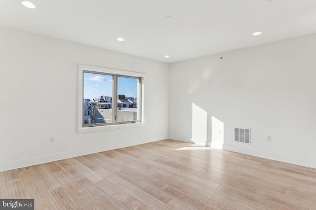 unfurnished room with light hardwood / wood-style floors