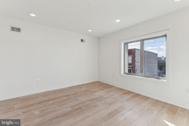 spare room featuring light hardwood / wood-style flooring