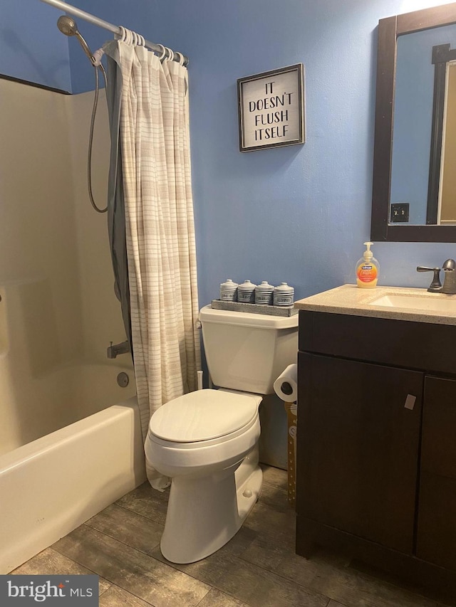 full bathroom featuring vanity, toilet, wood-type flooring, and shower / tub combo