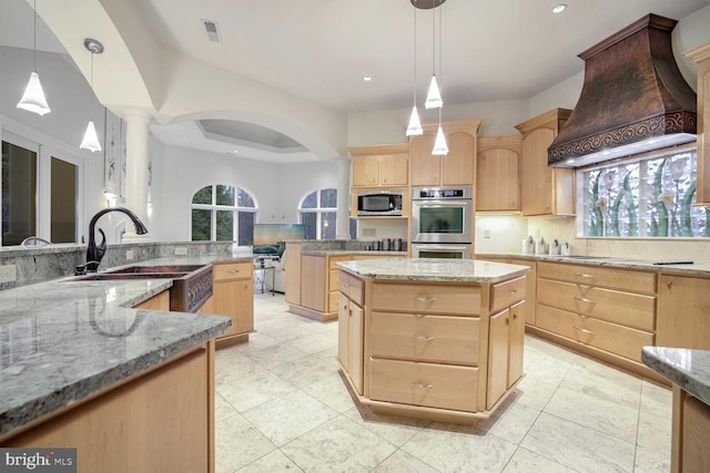 kitchen with sink, stainless steel appliances, pendant lighting, a kitchen island, and custom exhaust hood