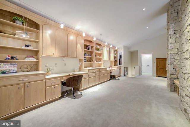 carpeted office with built in desk, built in features, and lofted ceiling