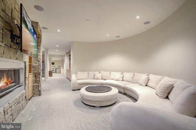 living room with light carpet and a fireplace