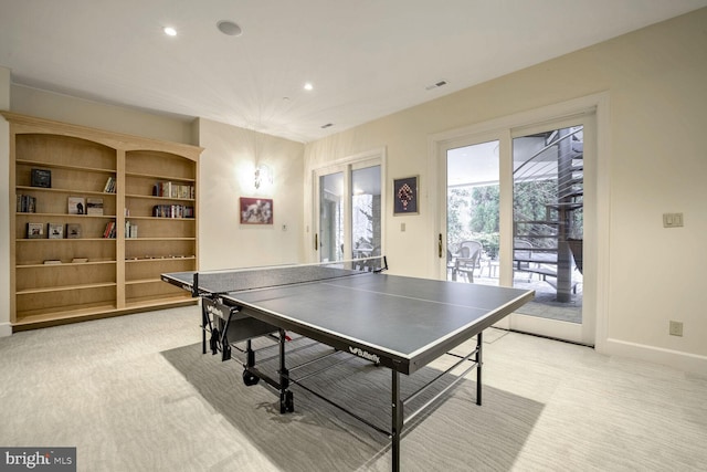 recreation room featuring light colored carpet