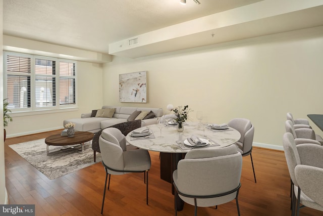 dining space with hardwood / wood-style flooring