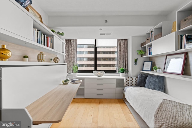 interior space with light hardwood / wood-style floors and built in desk