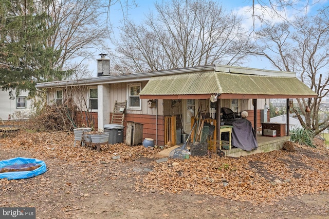 rear view of property with a chimney