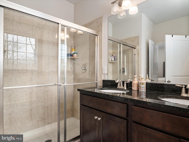 bathroom with vanity and a shower with shower door