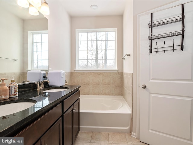 bathroom with vanity, a bathtub, a wealth of natural light, and tile patterned floors