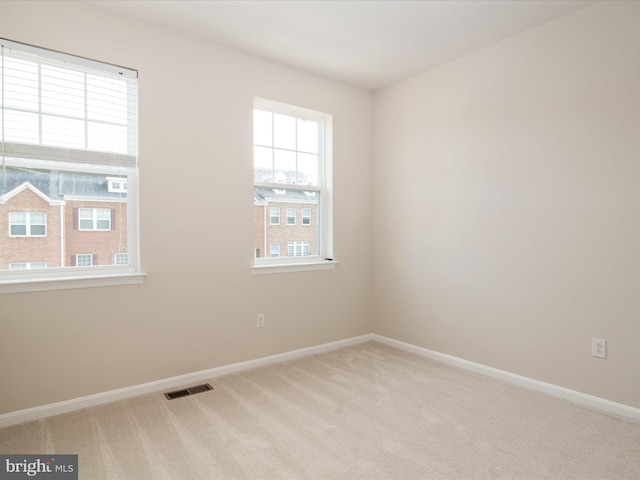 unfurnished room with light colored carpet