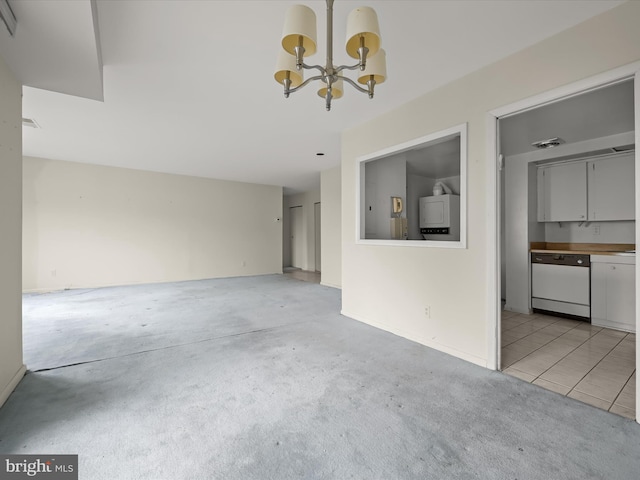 unfurnished living room featuring an inviting chandelier and light colored carpet