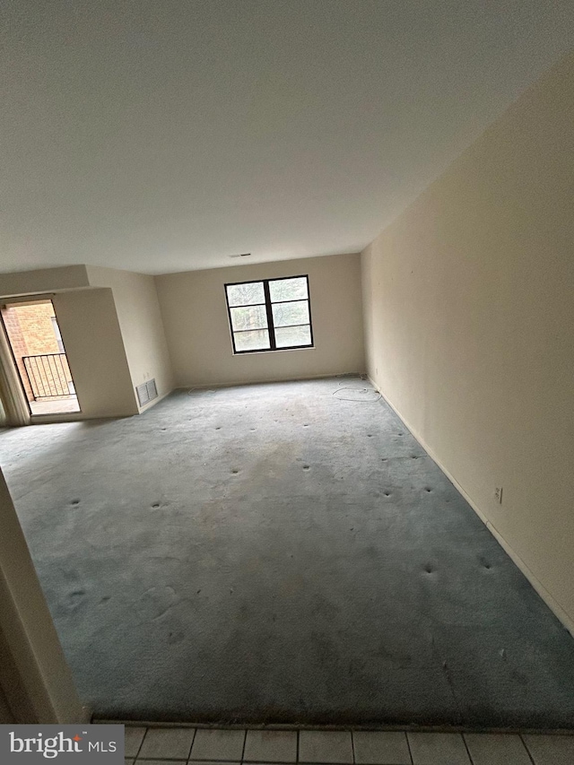 unfurnished room featuring light colored carpet