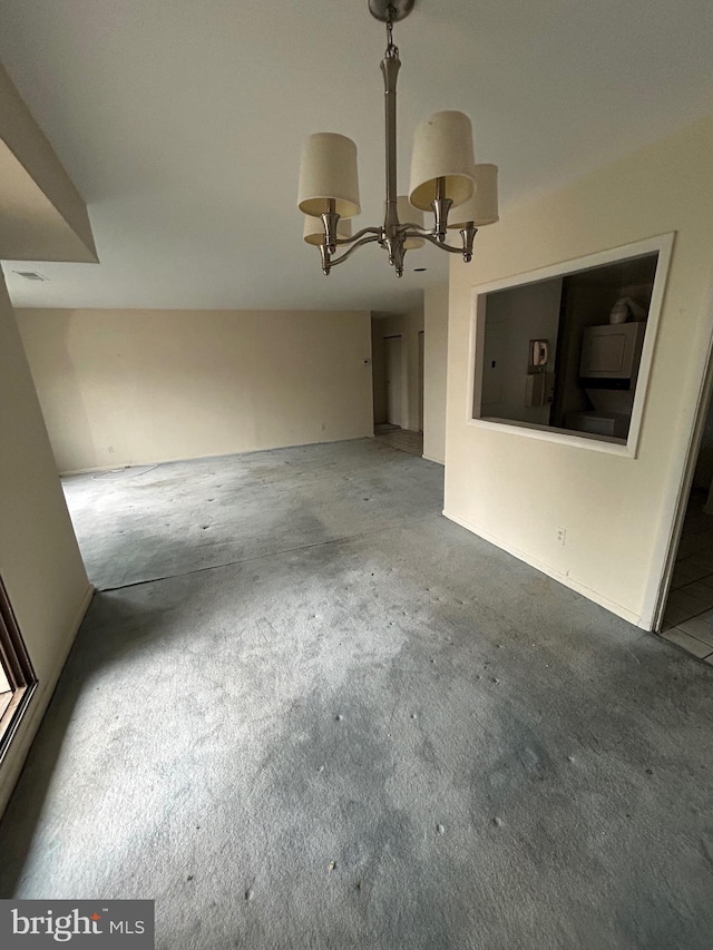 interior space featuring a chandelier and carpet floors