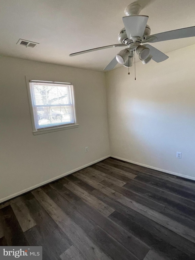 spare room featuring ceiling fan and dark hardwood / wood-style floors