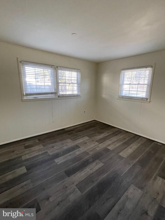 empty room featuring dark wood-type flooring