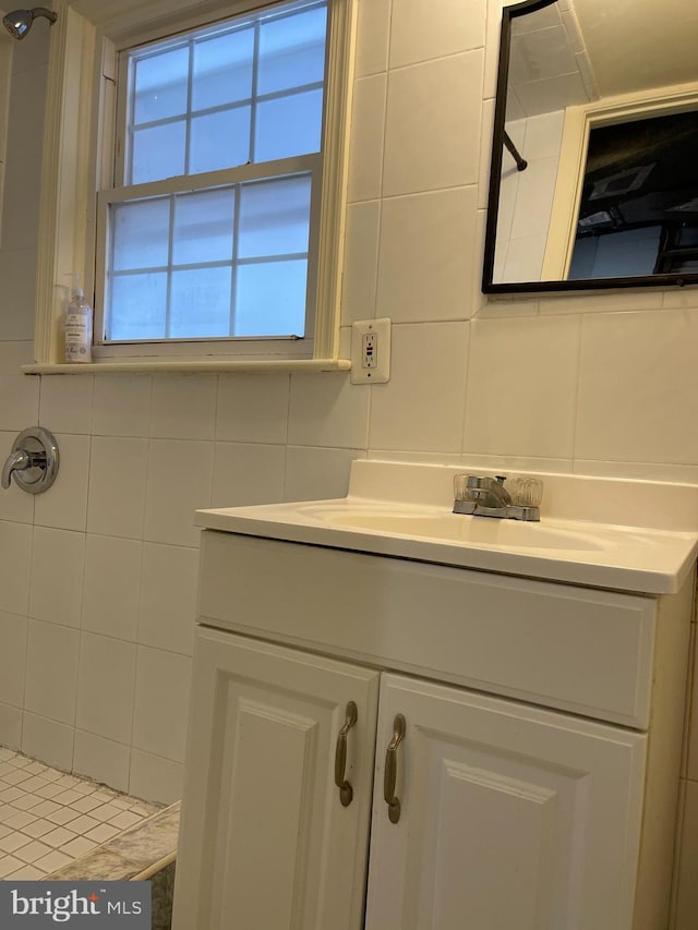 bathroom featuring vanity, tile walls, tasteful backsplash, and tiled shower