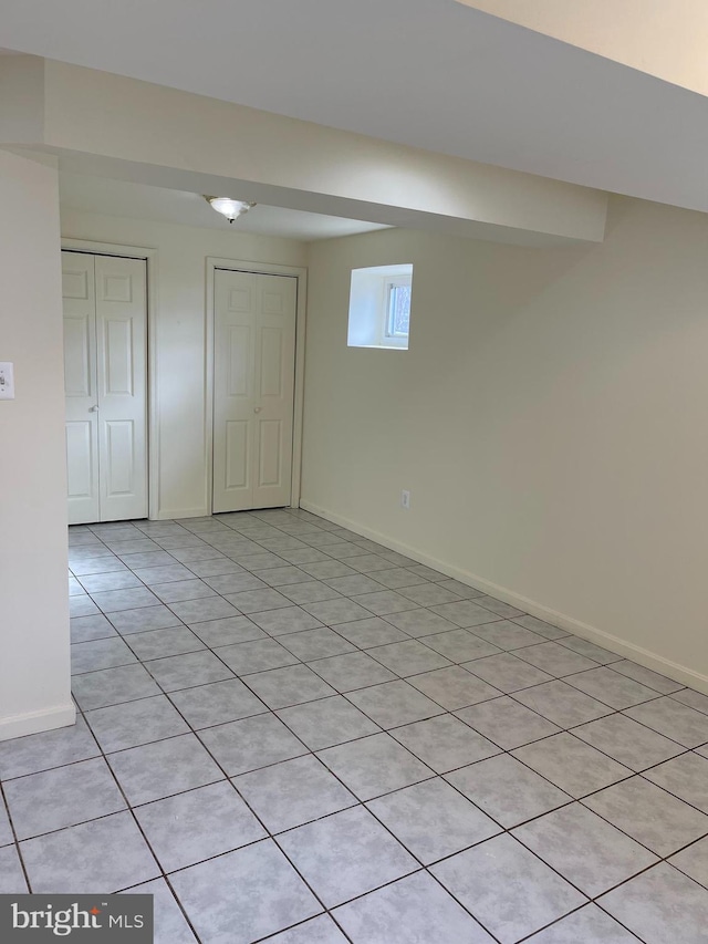 basement featuring light tile patterned floors