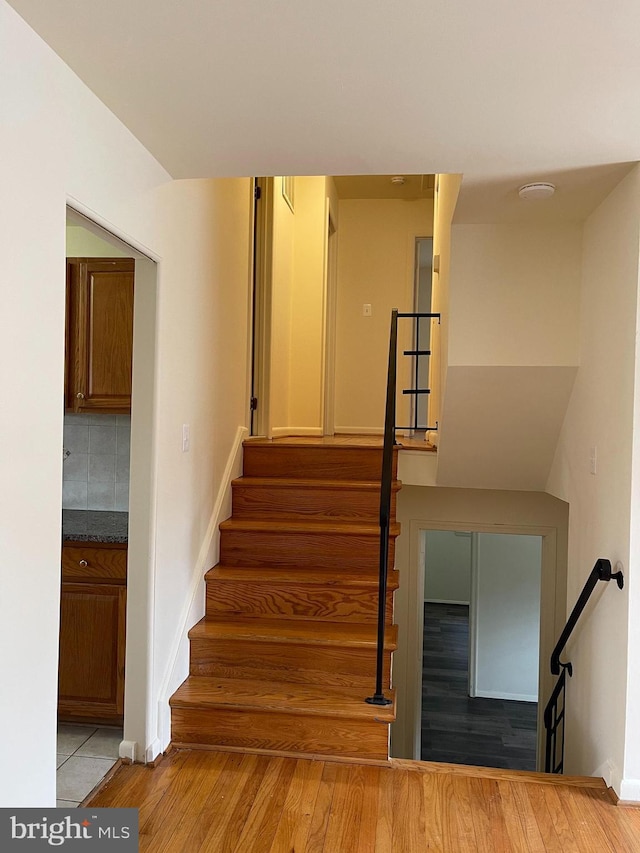 stairway with hardwood / wood-style flooring