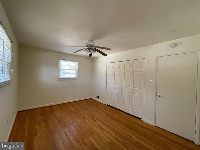 unfurnished bedroom with ceiling fan and wood-type flooring