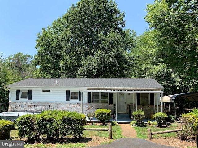 view of front of house featuring a carport and covered porch