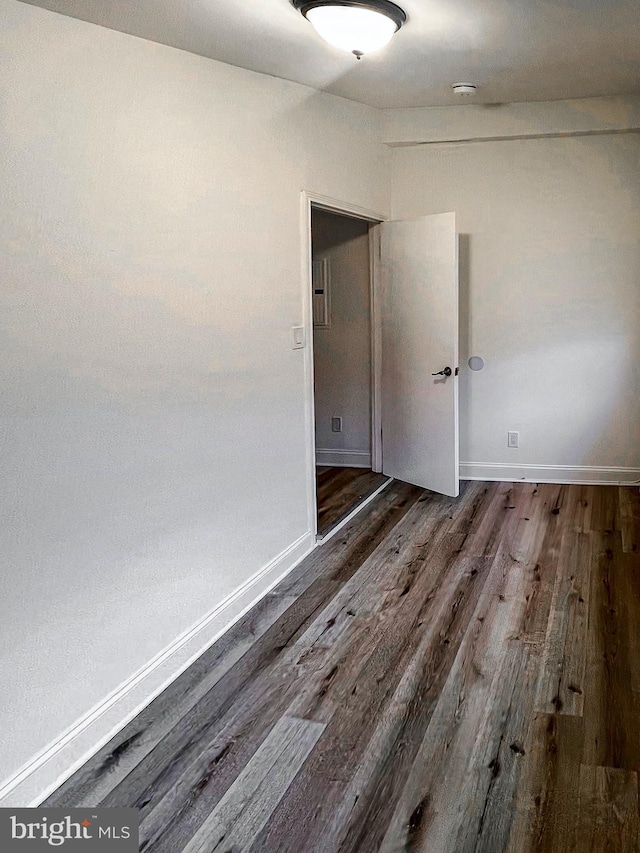 spare room with dark hardwood / wood-style floors