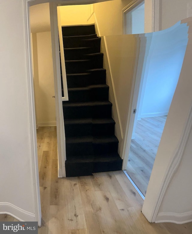 stairs with wood-type flooring