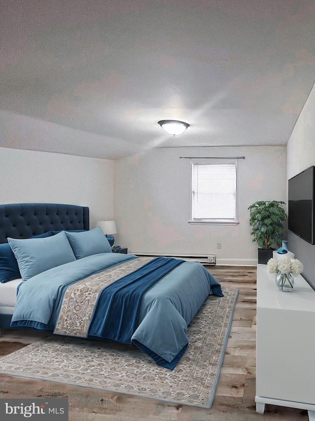 bedroom featuring a textured ceiling and hardwood / wood-style flooring