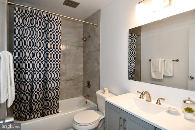 bathroom with toilet, visible vents, shower / bath combo with shower curtain, and vanity