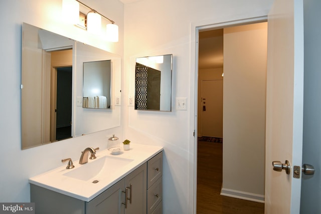 bathroom with wood finished floors and vanity