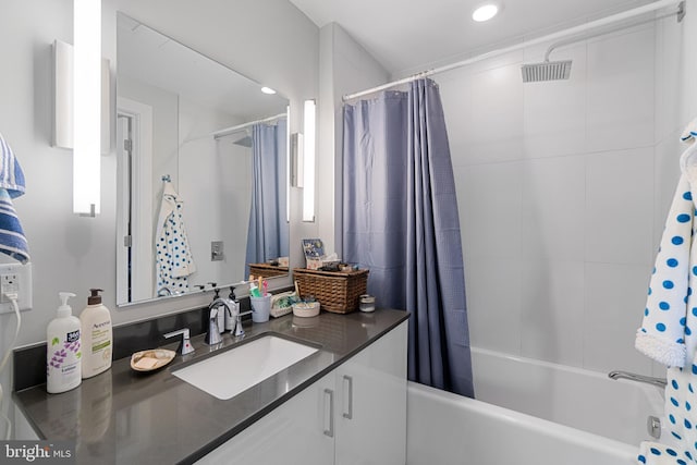 bathroom featuring shower / bath combo and vanity