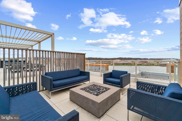 view of patio / terrace featuring a water view and an outdoor living space with a fire pit