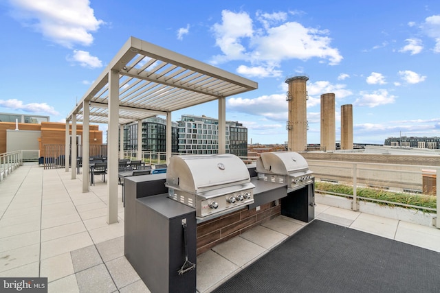 view of patio / terrace with a pergola, an outdoor kitchen, and a grill