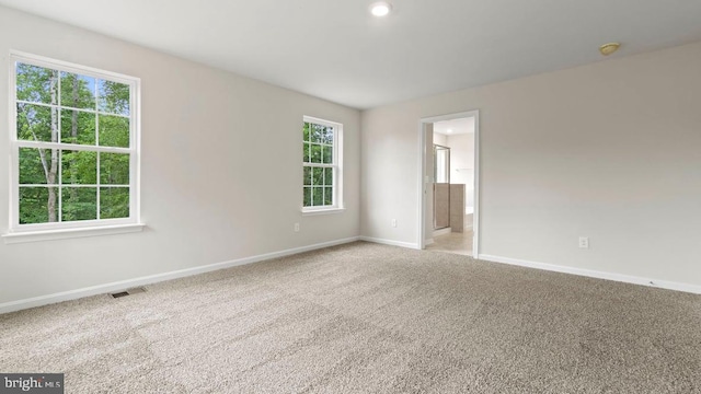 unfurnished room with light colored carpet